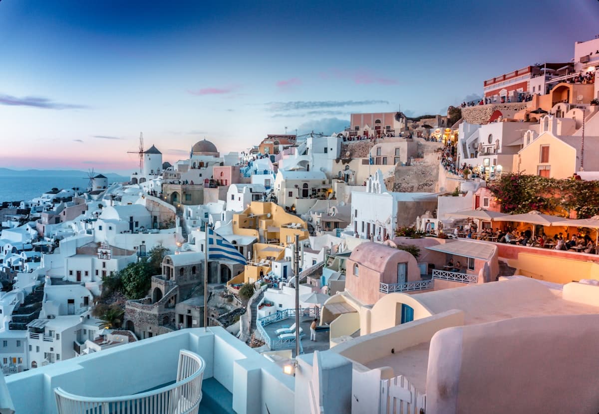 White-washed buildings overlooking the Santorini caldera at sunset